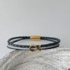das Armband mit Fisch Gold in schwarz blau