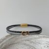 das Armband mit Fisch Gold schwarz blau